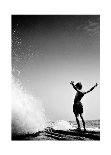 Boy in front of wave